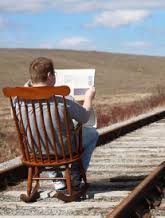 folly man sitting on rr tracks