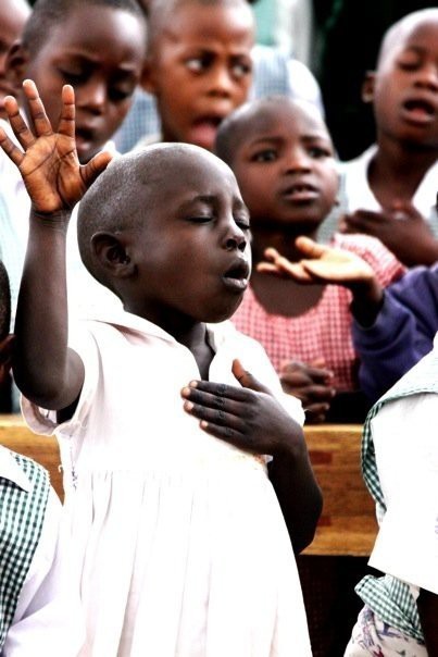 worshipping african boy
